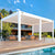 Modern white louverepergola with sleek design by a poolside, offering shaded outdoor seating.